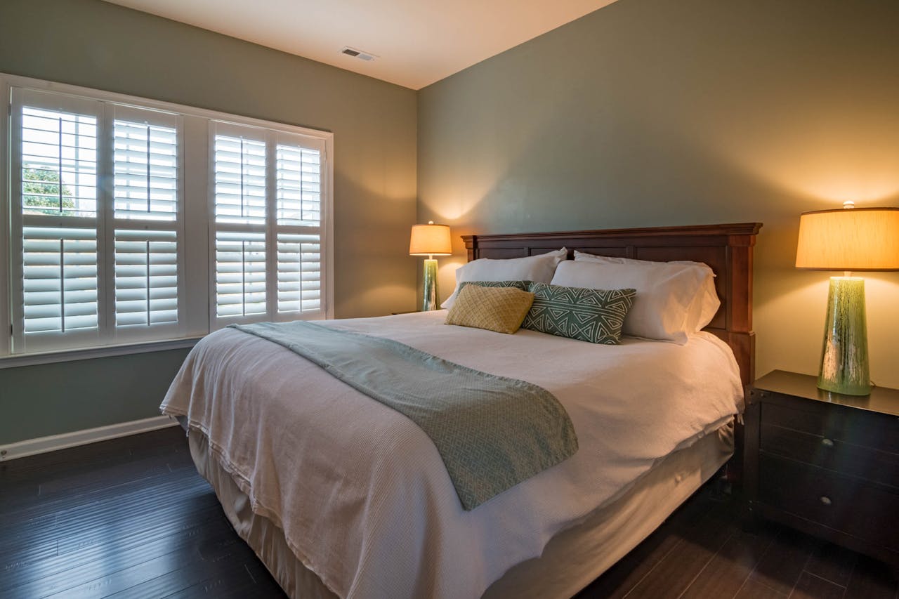 Stylish bedroom interior with cozy bed, elegant decor, and warm ambient lighting.